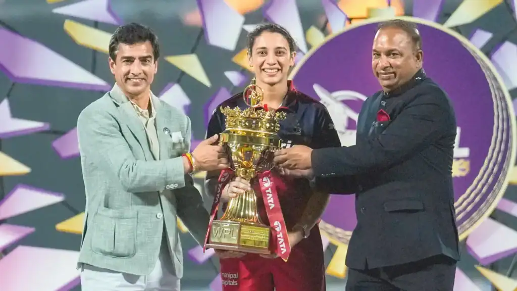 Smriti Mandhana celebrates with the WPL trophy after RCB Women win the 2026 title